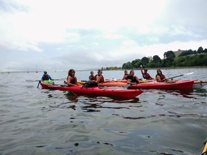 a group of people in a small boat in a body of water