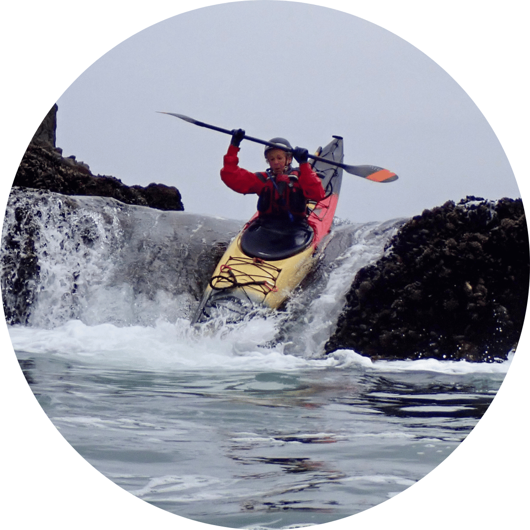 a man riding on the back of a boat in the water