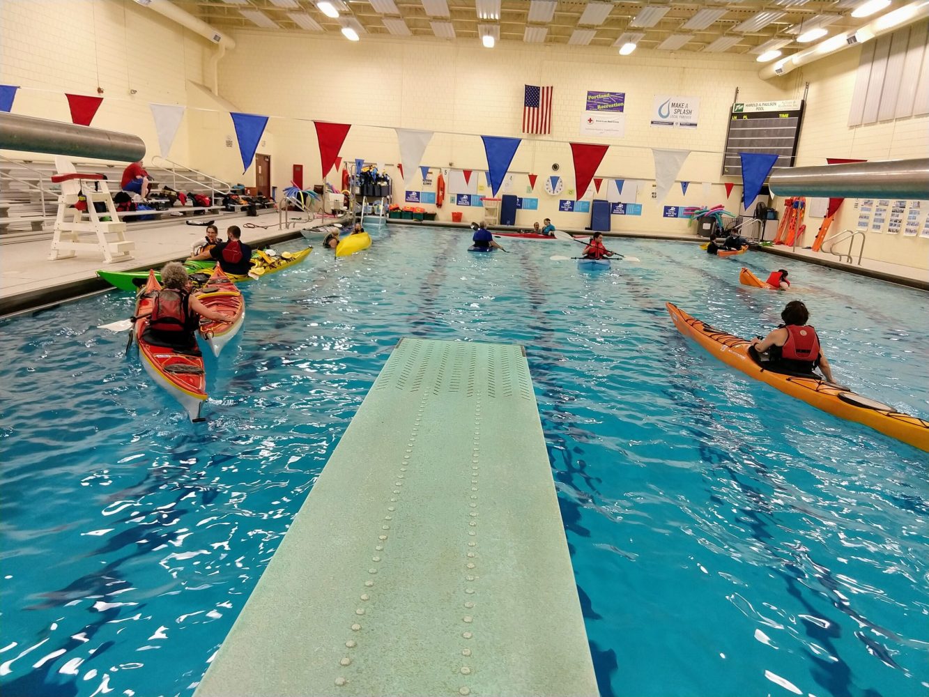 a group of people swimming in a pool of water